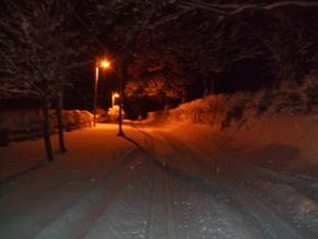 snow covered road at night